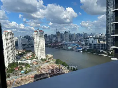 Stunning cityscape view from high-rise balcony overlooking river and skyline.