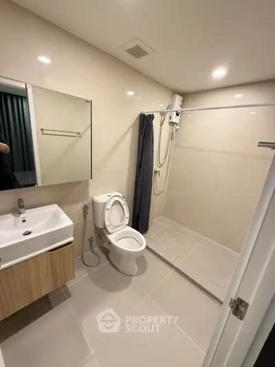 Modern bathroom with sleek fixtures and spacious shower area