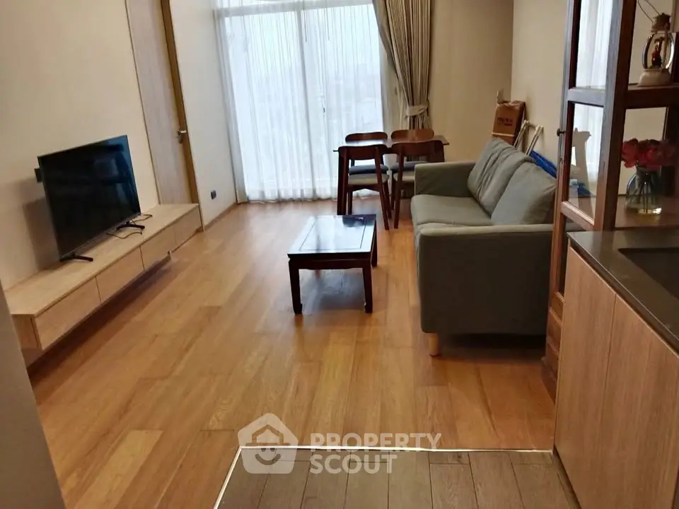 Spacious living room with modern furniture and large windows for natural light.