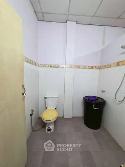 Spacious bathroom with modern fixtures and ample storage space.