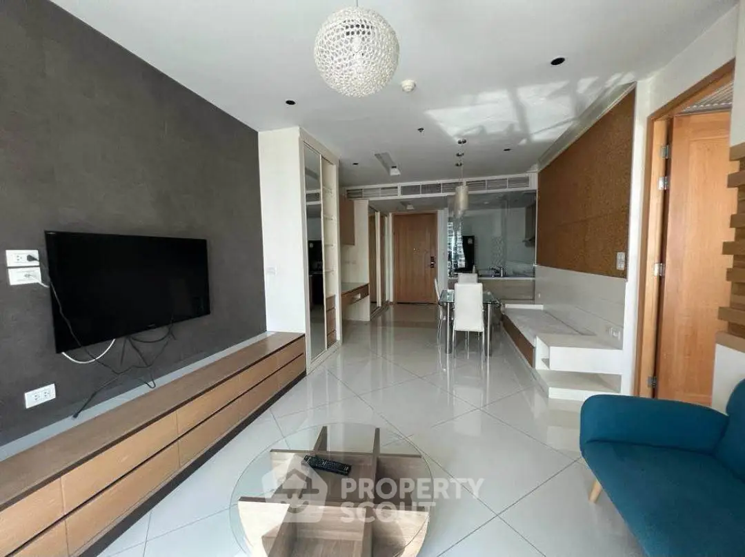 Modern living room with sleek furniture and wall-mounted TV in a stylish apartment.