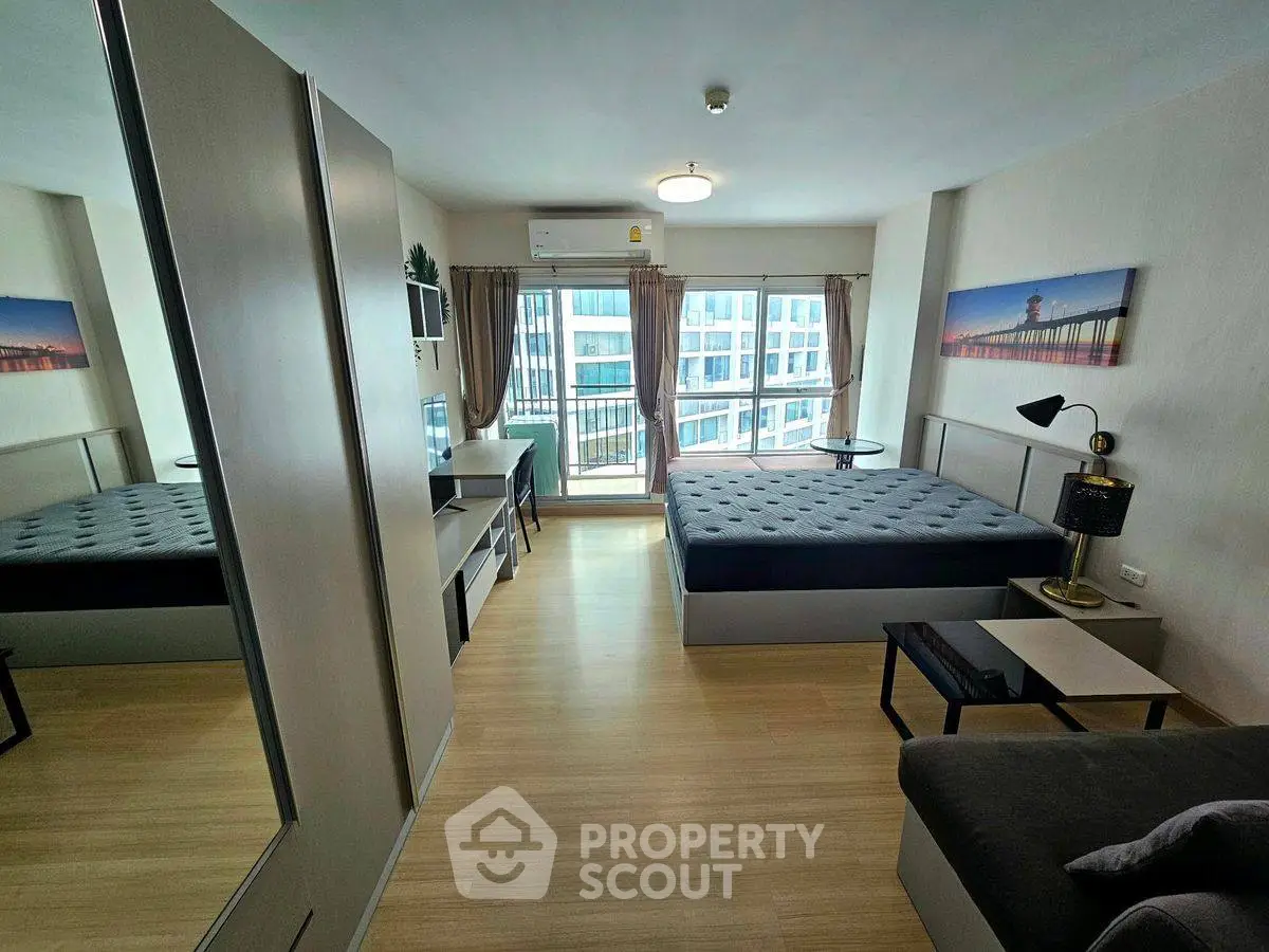 Modern studio apartment with large windows and stylish decor