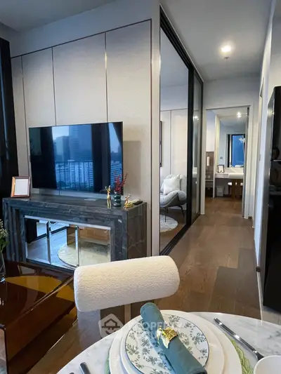 Modern living room with stylish decor and open view to bedroom