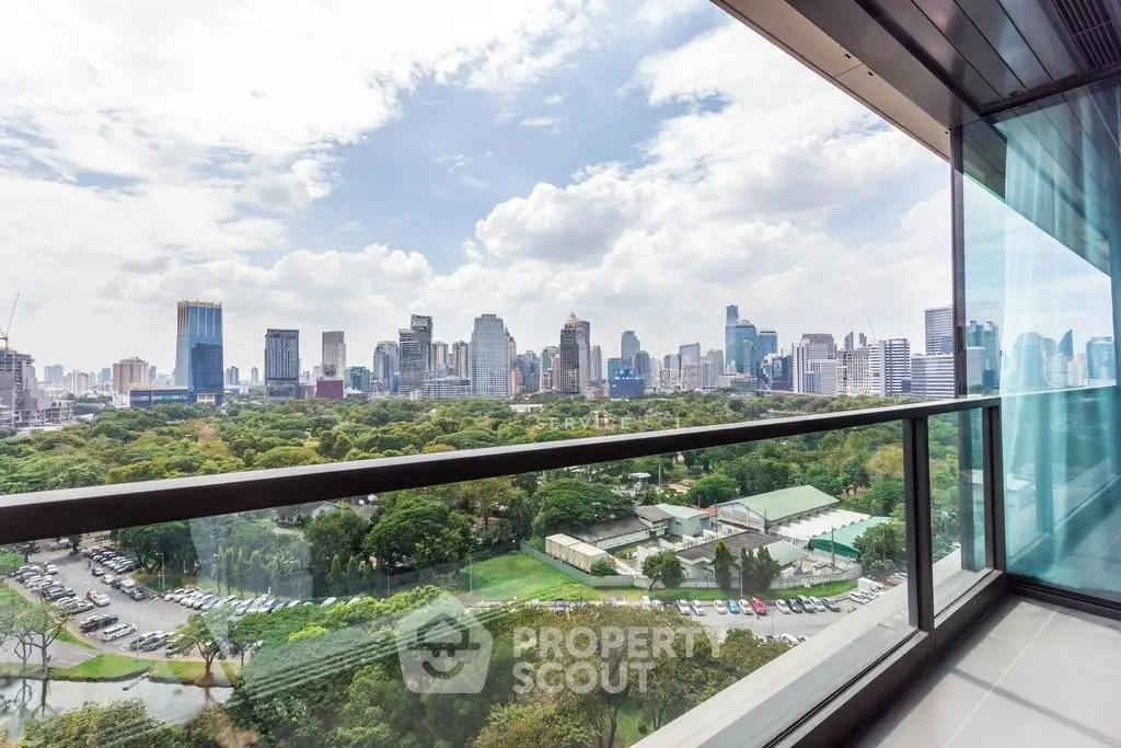 Stunning cityscape view from a modern balcony overlooking lush greenery and skyline.