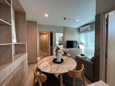 Modern living room with open layout and stylish decor, featuring a cozy dining area and natural light.