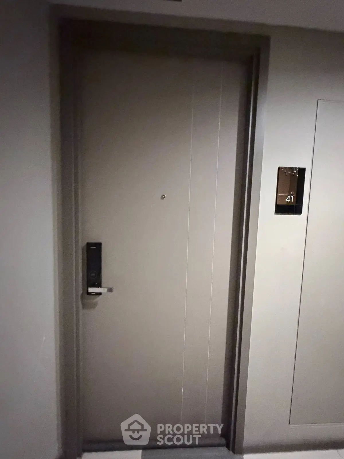 Modern apartment entrance with secure electronic lock and sleek design.