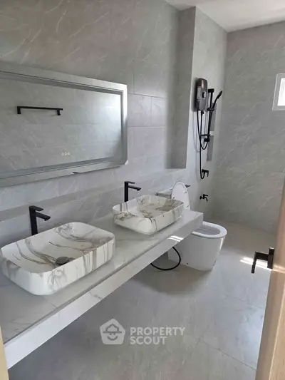Luxurious modern bathroom with dual marble sinks and sleek fixtures