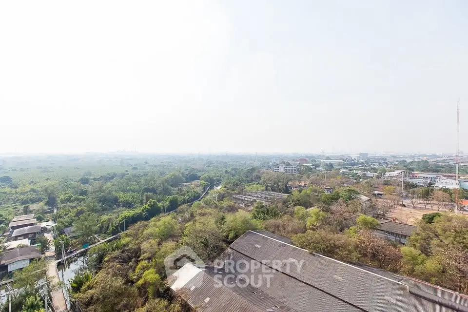 Stunning aerial view of lush greenery and urban landscape, perfect for real estate development.