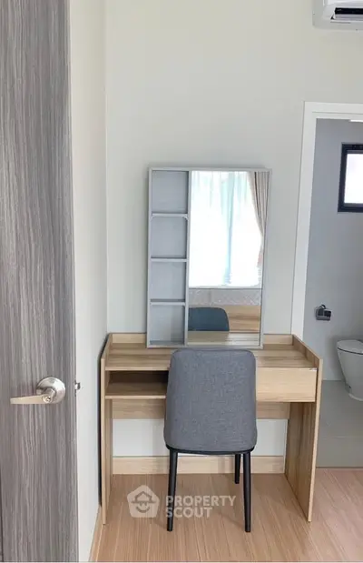 Stylish bedroom corner with modern vanity and chair, perfect for a cozy and functional space.
