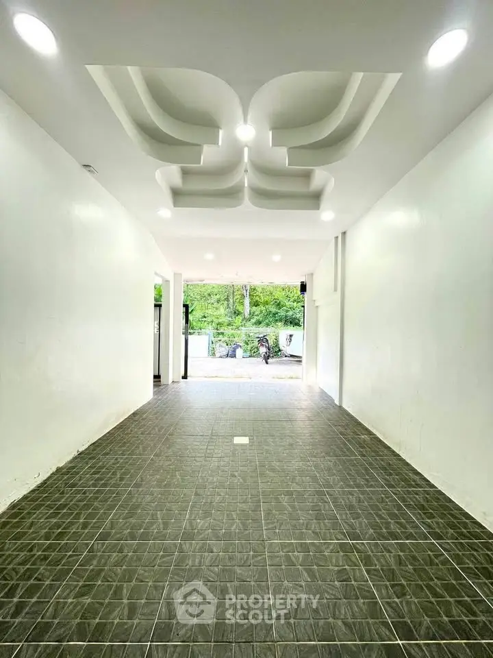 Spacious modern entrance with stylish ceiling design and tiled flooring, perfect for welcoming guests.
