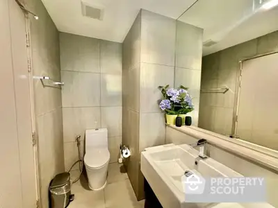 Modern bathroom with sleek fixtures and elegant tile design.