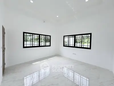 Spacious empty room with large windows and glossy tiled floor, perfect for customization.