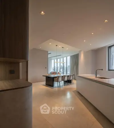 Luxurious open-plan kitchen and dining area with modern design and city view.