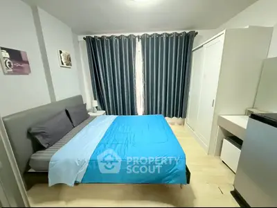 Modern bedroom with stylish decor and natural light, featuring a comfortable bed and sleek furnishings.