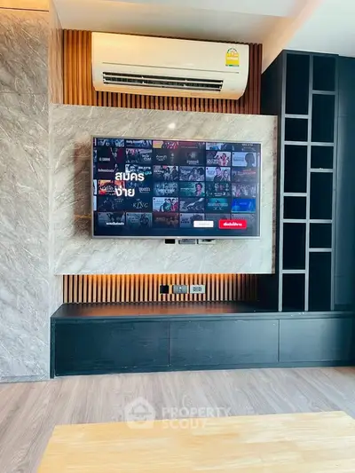 Modern living room with wall-mounted TV and air conditioning unit, featuring sleek cabinetry and wood accents.