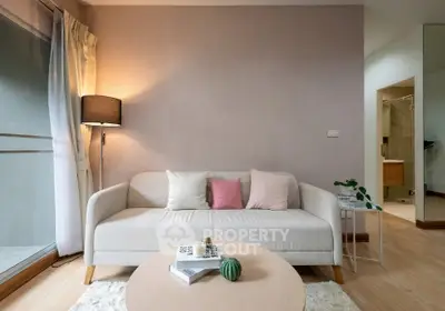 Cozy living room with modern sofa and soft lighting, perfect for relaxation.