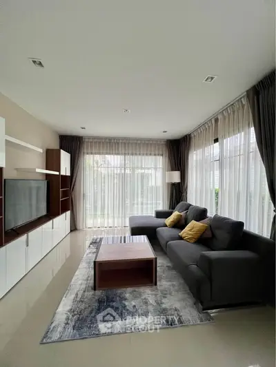 Spacious modern living room with large windows and stylish furniture