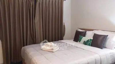 Cozy bedroom with elegant curtains and neatly arranged bed, perfect for relaxation.