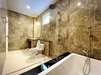 Luxurious marble bathroom with modern fixtures and bathtub