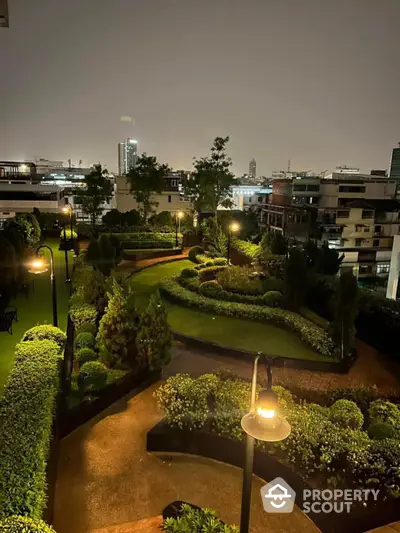 Stunning night view of a beautifully landscaped garden in a modern residential complex.