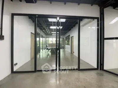 Modern office space with glass partitions and open layout