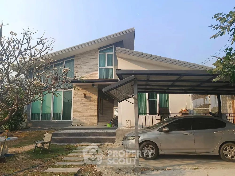 Modern single-story house with carport and landscaped garden