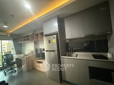 Modern studio apartment with sleek kitchen and workspace