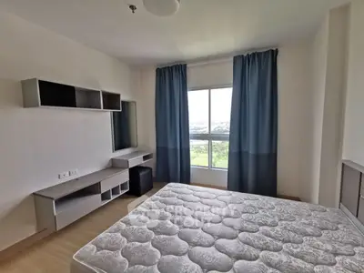 Modern bedroom with large window and minimalist furniture, offering a bright and airy atmosphere.