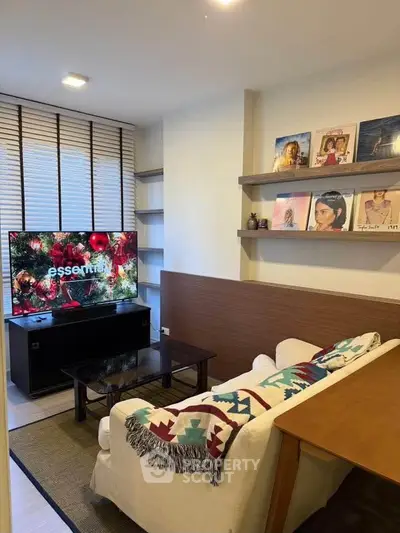 Cozy living room with modern decor and wall-mounted shelves, perfect for relaxation and entertainment.