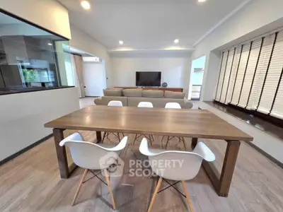 Spacious modern living room with dining area and stylish furniture, perfect for family gatherings.