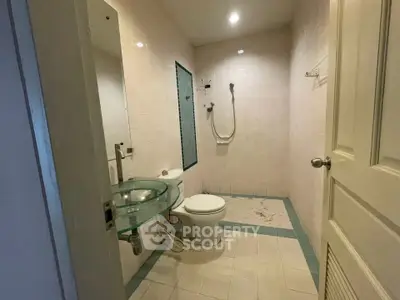 Modern bathroom with glass sink and shower in a real estate property