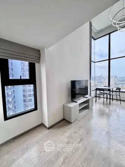 Modern high-rise apartment with stunning city view and sleek interior design.