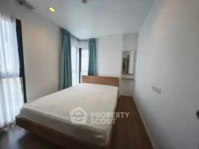 Spacious bedroom with large windows and modern decor