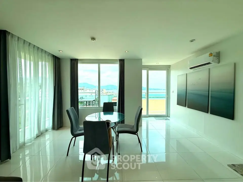 Spacious modern dining area with panoramic windows and elegant decor