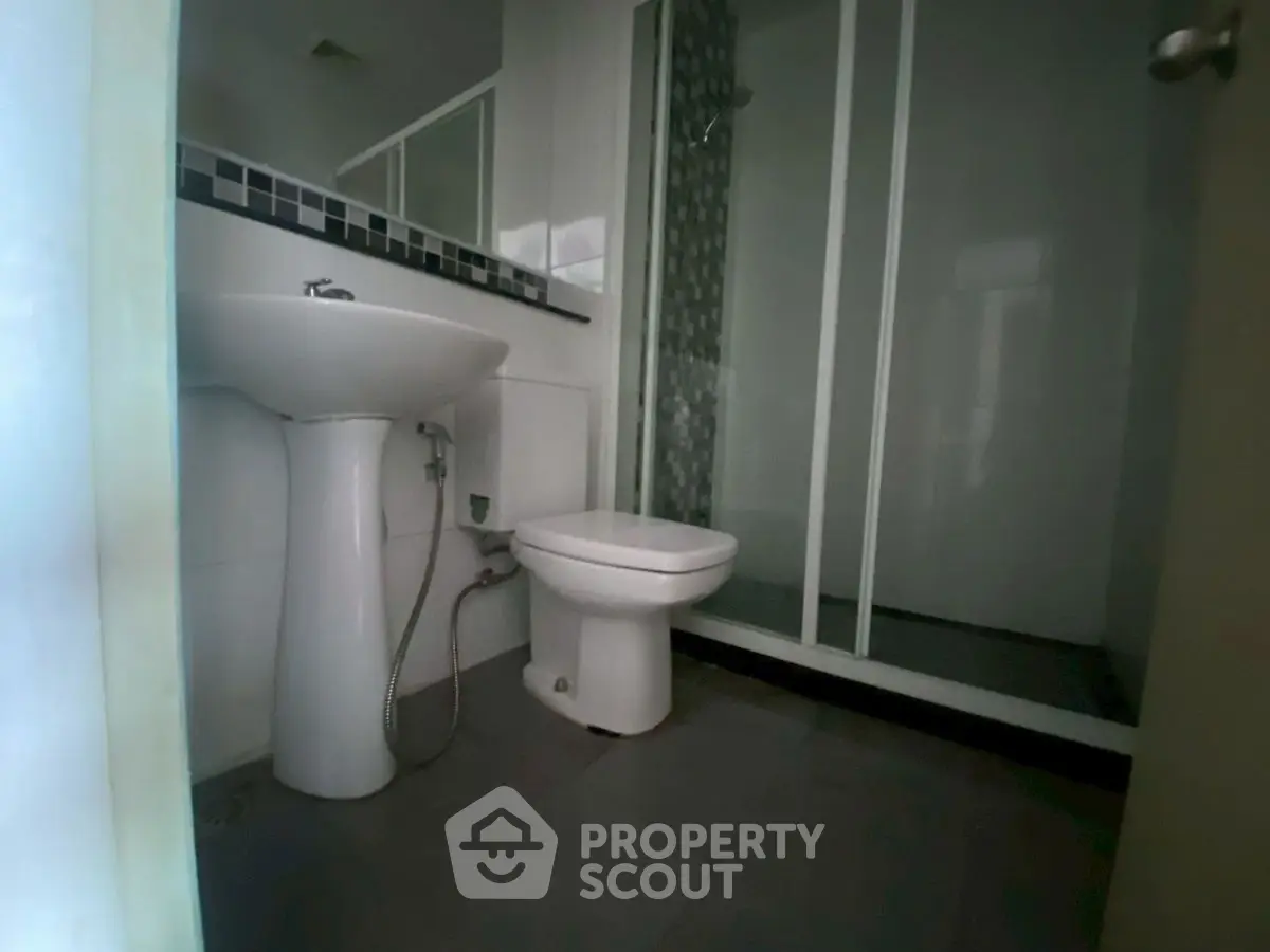 Modern bathroom with sleek shower and pedestal sink