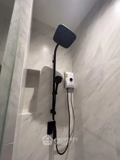 Modern bathroom with sleek showerhead and elegant marble tiles