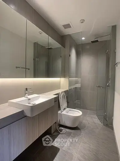 Modern bathroom with sleek fixtures and glass shower enclosure