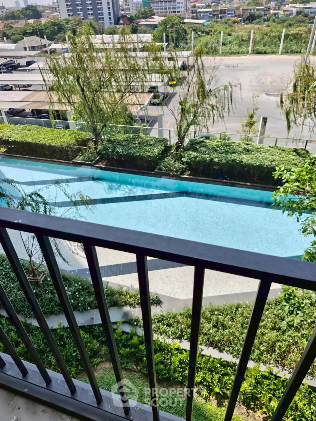 Stunning pool view from balcony in modern urban apartment complex.
