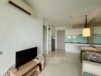 Modern open-layout living room with sleek kitchen and stylish decor
