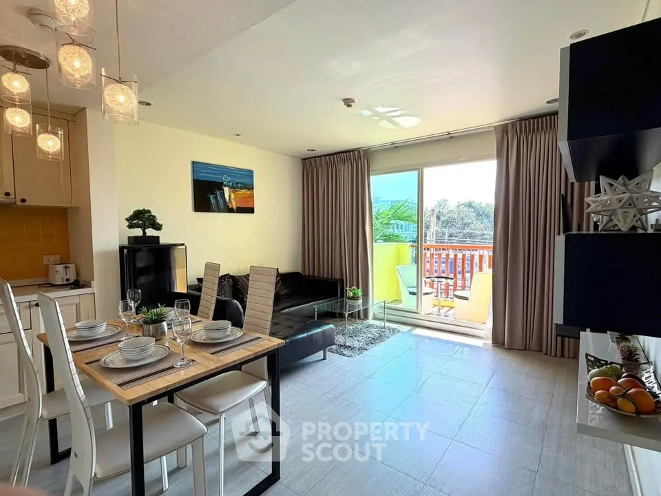 Modern open-plan living room with dining area and balcony access, featuring stylish decor and ample natural light.