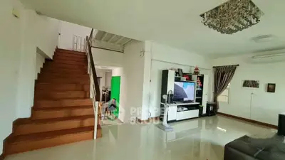 Spacious living room with modern decor and staircase in a stylish home