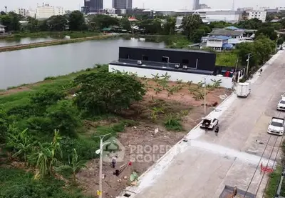 Aerial view of a residential area with a lake, showcasing potential for development.