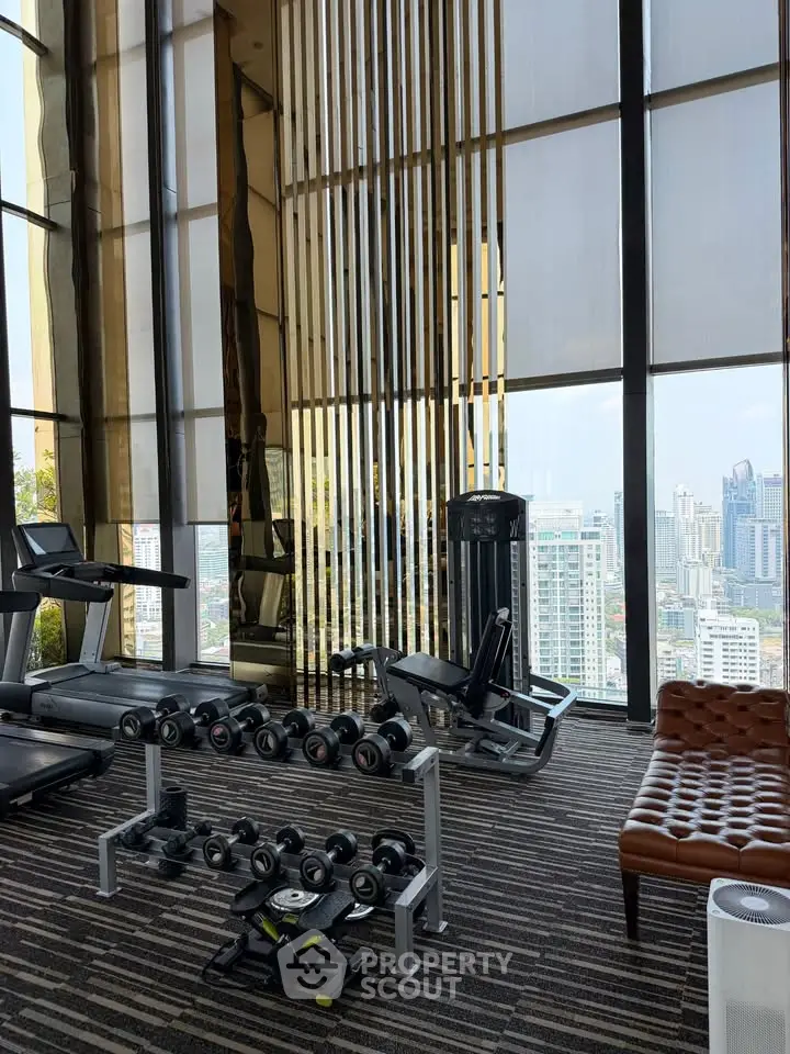 Luxurious high-rise gym with city view, featuring modern equipment and stylish decor.