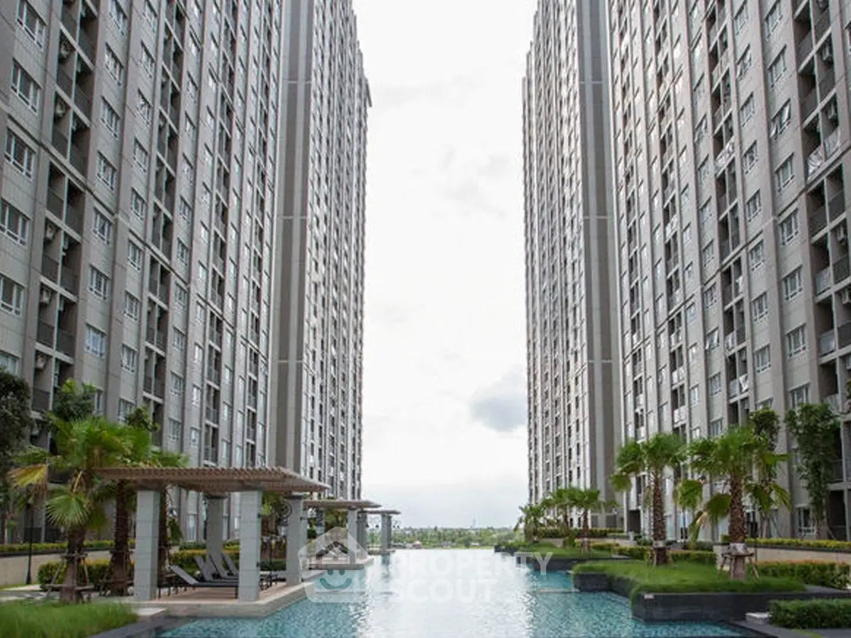 Luxurious high-rise apartment complex with stunning pool and lush landscaping.