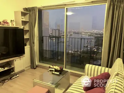 Cozy living room with stunning city view from high-rise balcony.