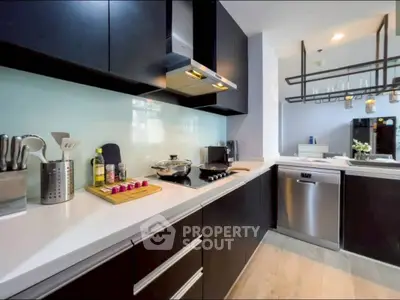 Modern kitchen with sleek cabinetry and stainless steel appliances, featuring a stylish open layout.