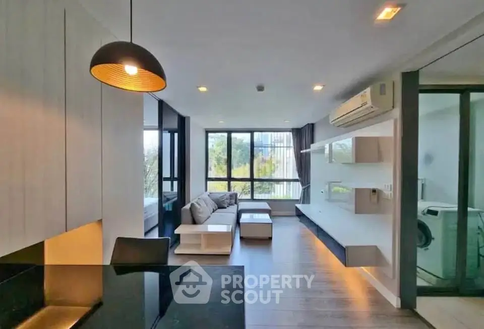 Modern living room with stylish decor and large windows offering natural light