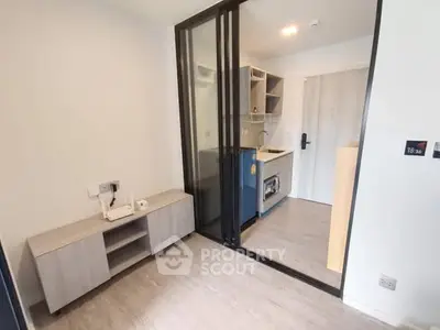 Modern compact kitchen with sliding glass door and sleek cabinetry