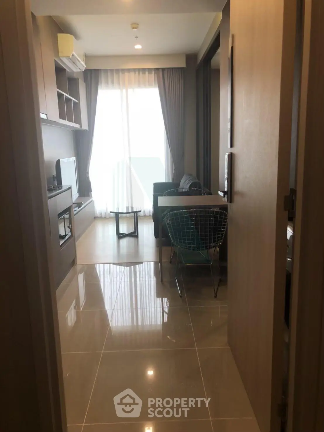 Modern living room with sleek design and natural light in a stylish apartment.