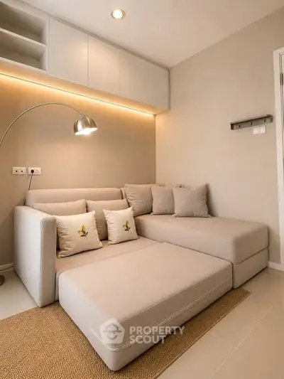 Modern living room with cozy beige sectional sofa and stylish floor lamp
